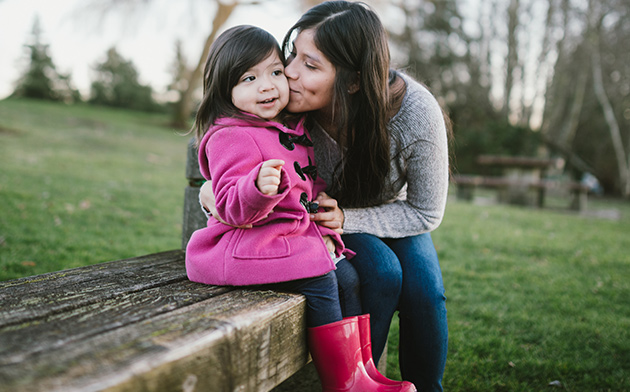 Mother kissing daughter on cheek