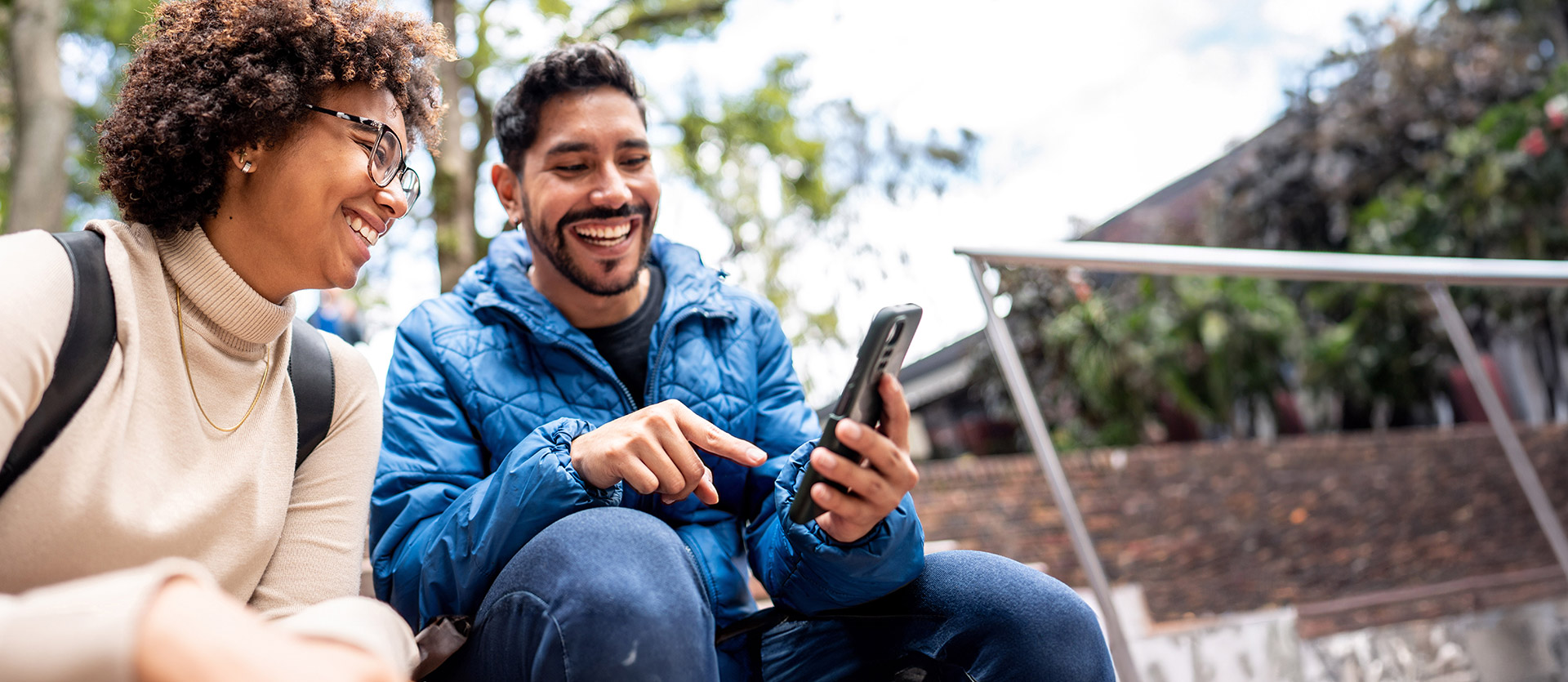 Man and woman looking at phone. 