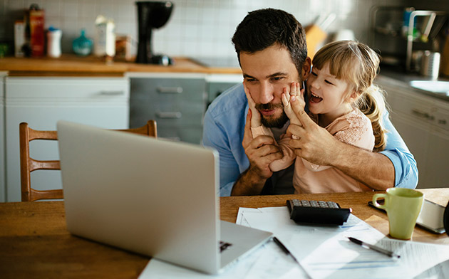 Father and daughter at a laptop