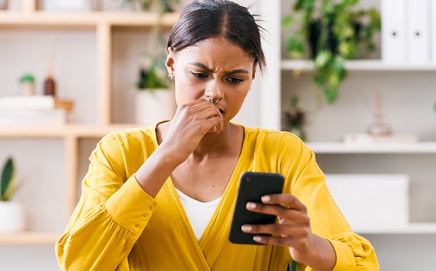 Concerned woman looking at phone