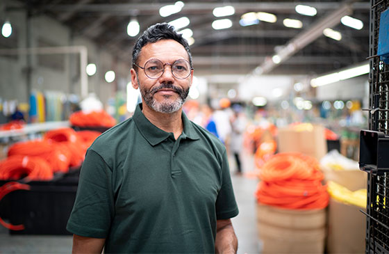 Large enterprise business owner standing inside production facility