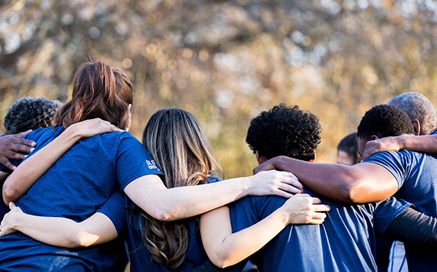 People with arms around each other