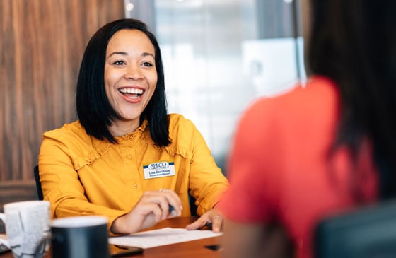 SELCO community credit union team member helping a women